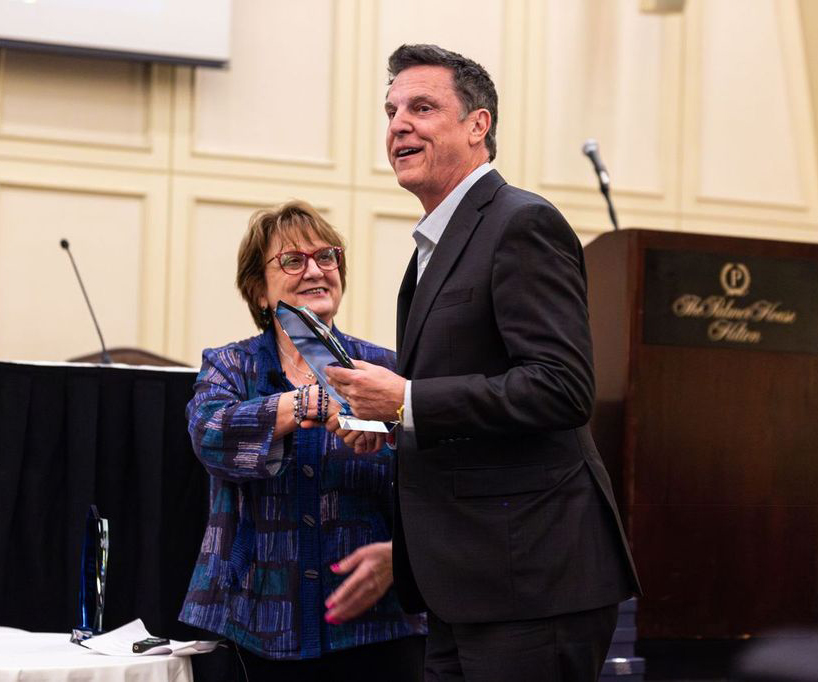 Roz Applebaum of the Strategic Solutions Network presents Tim Meenan of Meenan P.A. with his Warranty Industry Champion award, September 24, 2024